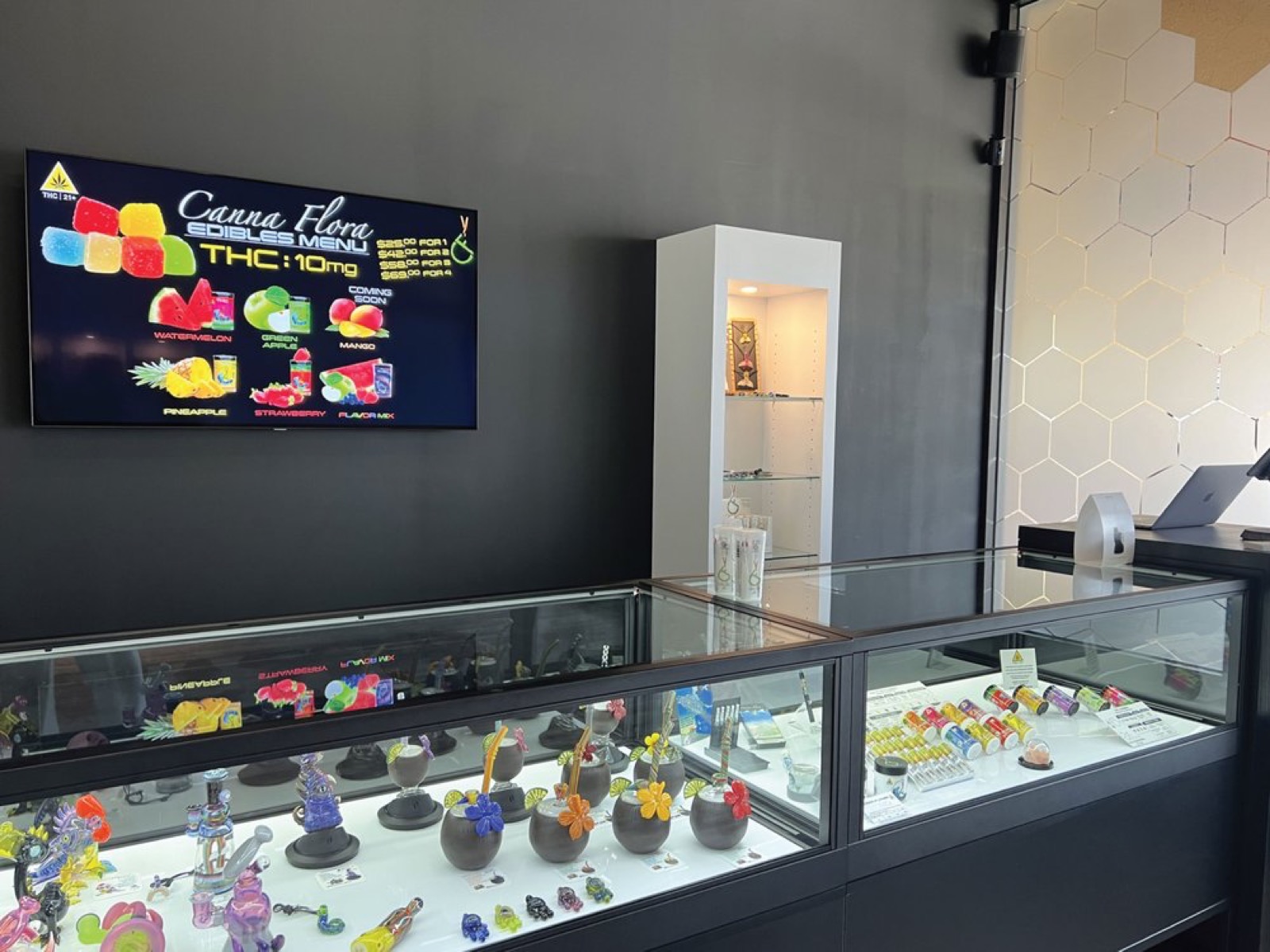 A glass display case of products at Canna Flora