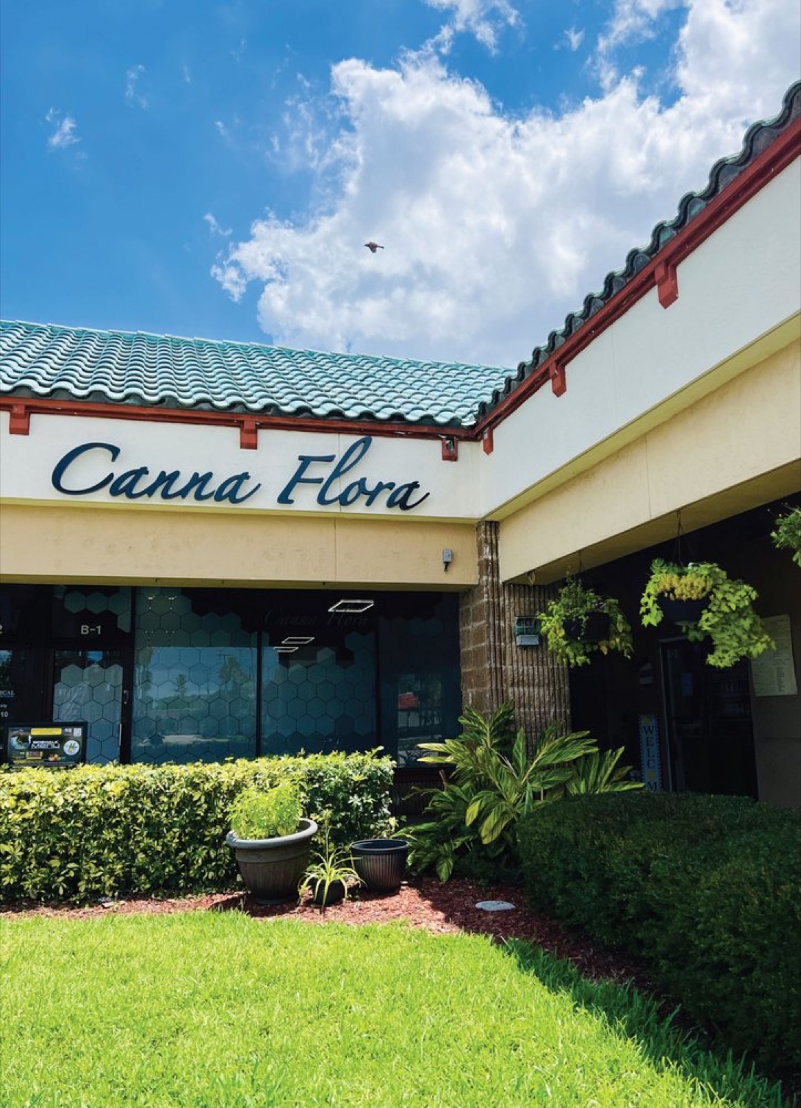 Canna Flora storefront exterior and sign on a sunny day in Jupiter, FL